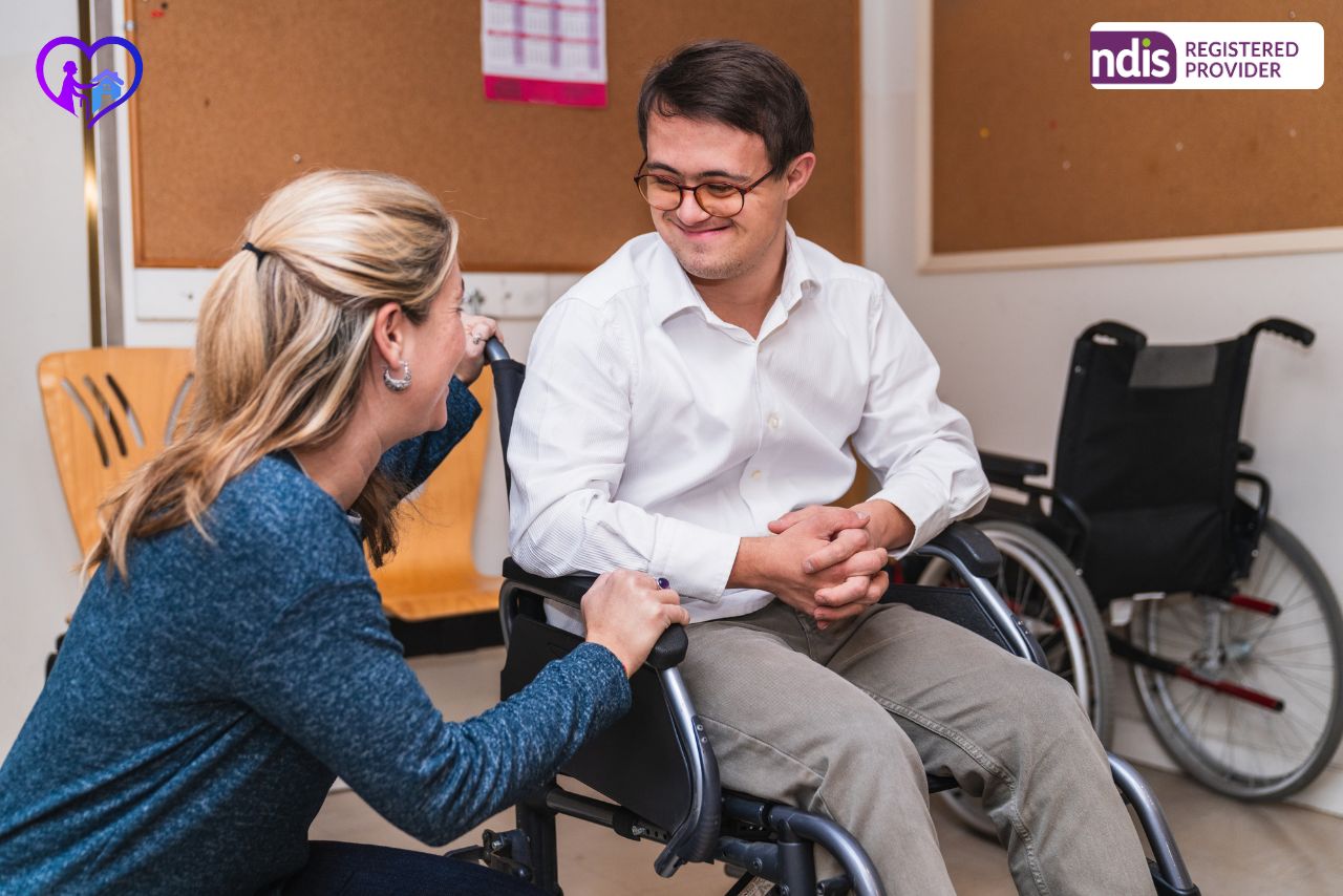 Best NDIS support-coordination service in Australia - A friendly NDIS Support Coordinator in Brisbane discusses a plan with a smiling participant.